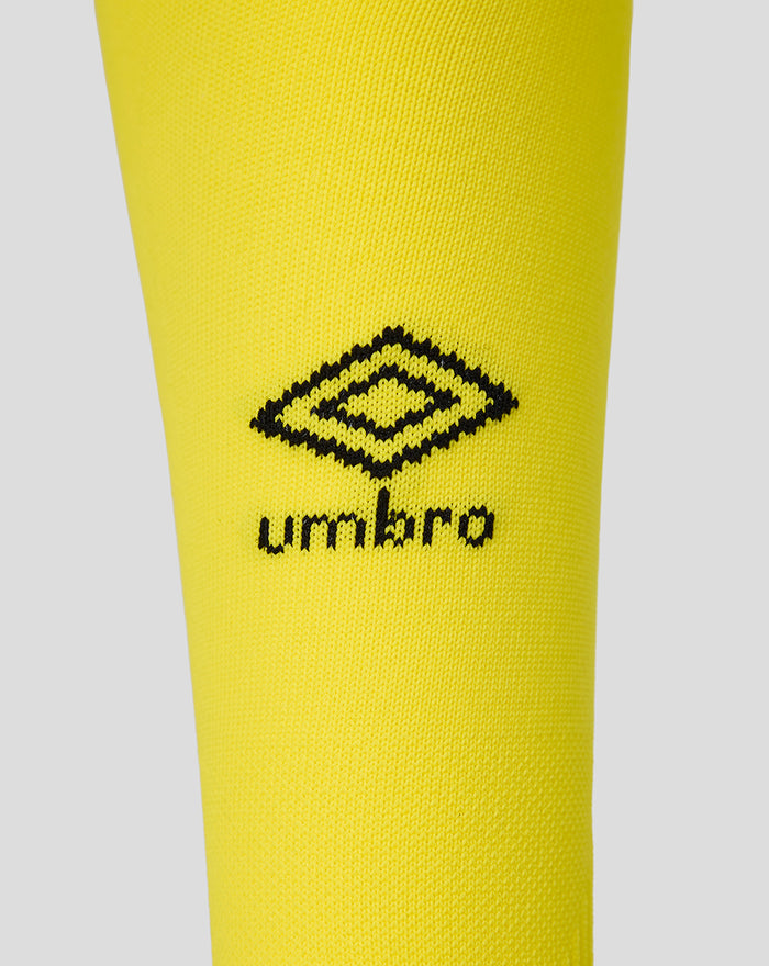 Close-up of bright yellow away sock showing the Umbro logo