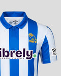 Chest view of Sheffield Wednesday home shirt with yellow SWFC crest, Umbro logo, and large sponsor graphic across the front