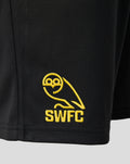 Close-up of the yellow SWFC crest embroidered on black shorts