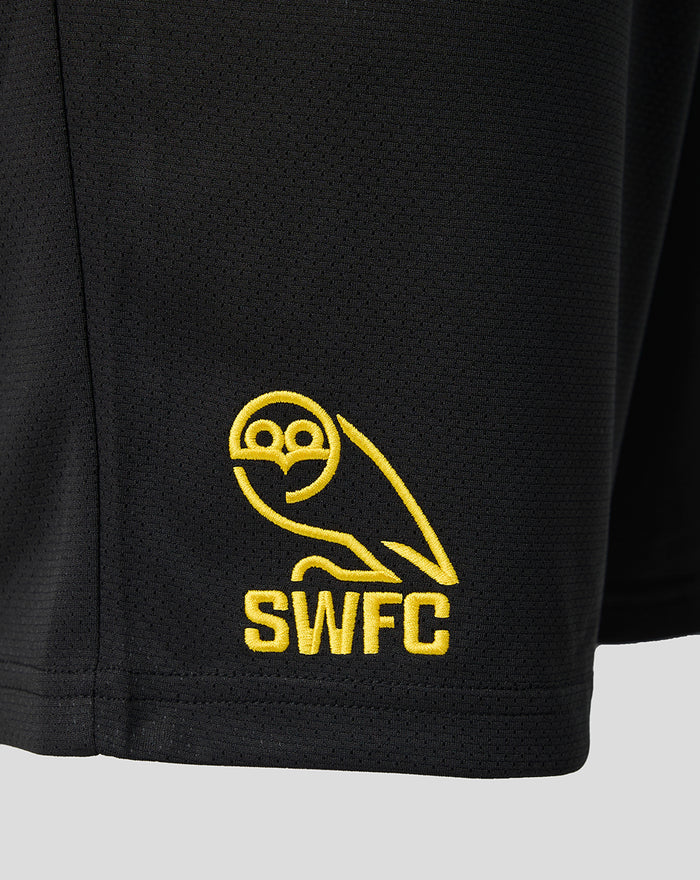 Close-up of the yellow SWFC crest embroidered on black shorts