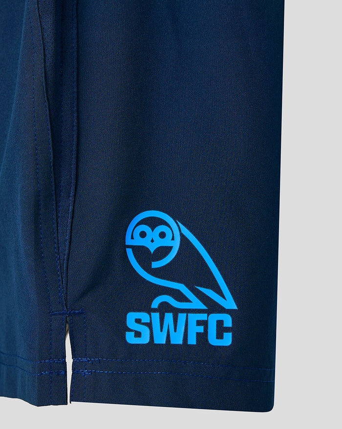 Navy shorts with bright blue SWFC owl crest on the leg.