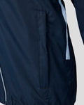 Close up of navy training jacket showing a vertical side pocket and blue detailing along the side seam.