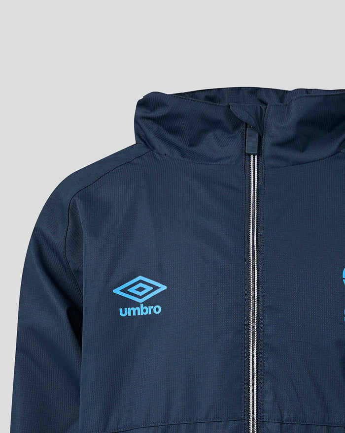 Close up of navy jacket chest showing blue Umbro logo on the left and the front zipper