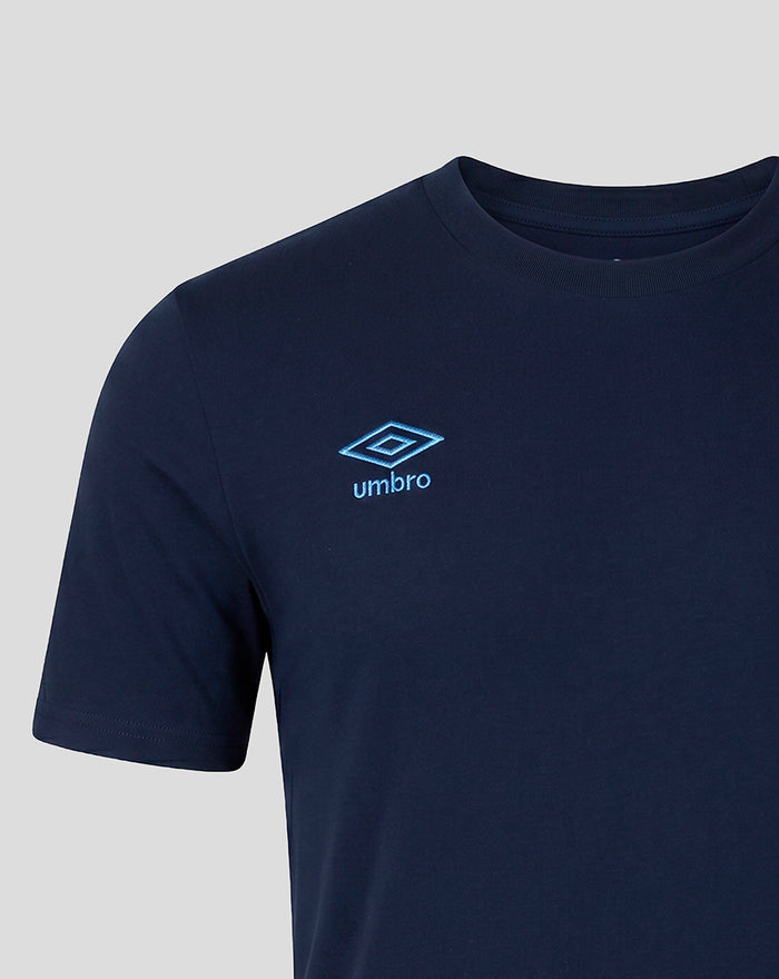 Close up of navy travel tee showing blue Umbro logo on the chest.
