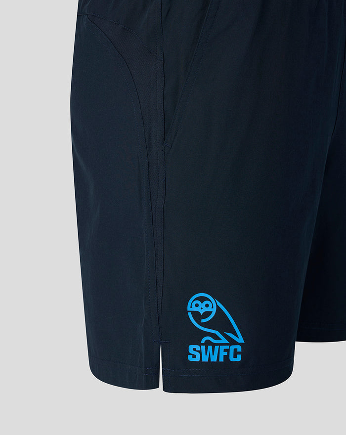 Side view of navy training shorts showing the SWFC logo on the lower leg and a small hem vent.