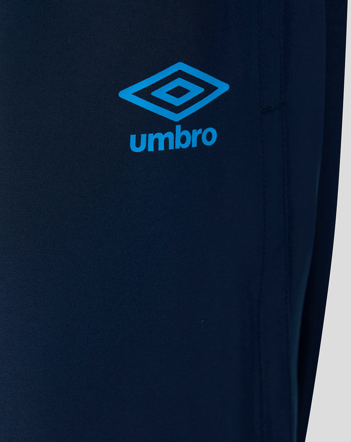 Close-up of navy training pants showing the bright blue Umbro logo.