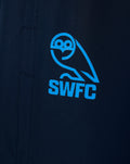 Close up of the blue SWFC logo on dark navy training pants